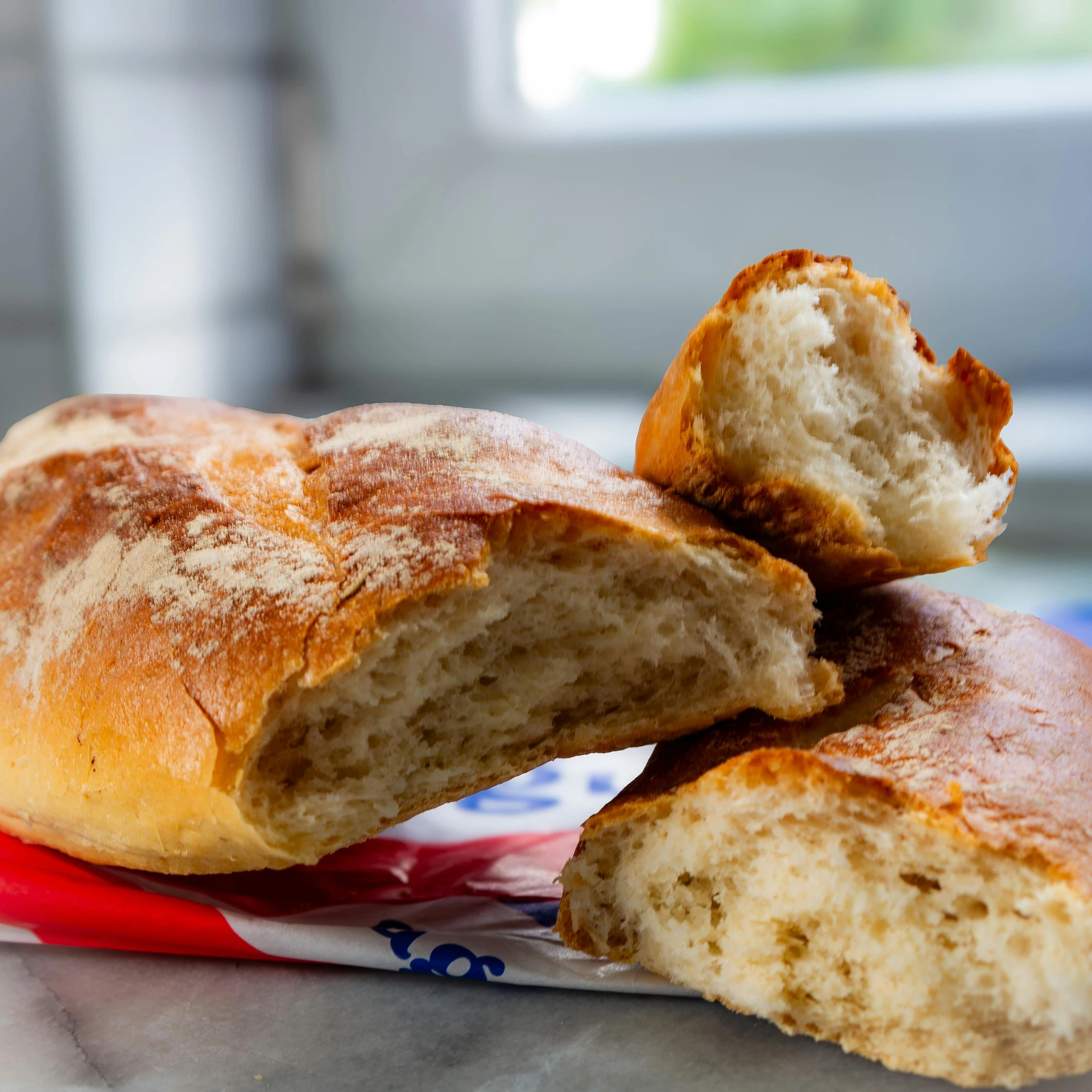 Soft fluffy artisan bread roll torn open showing light airy crumb at Vonado Cookie and Bread in Hanoi