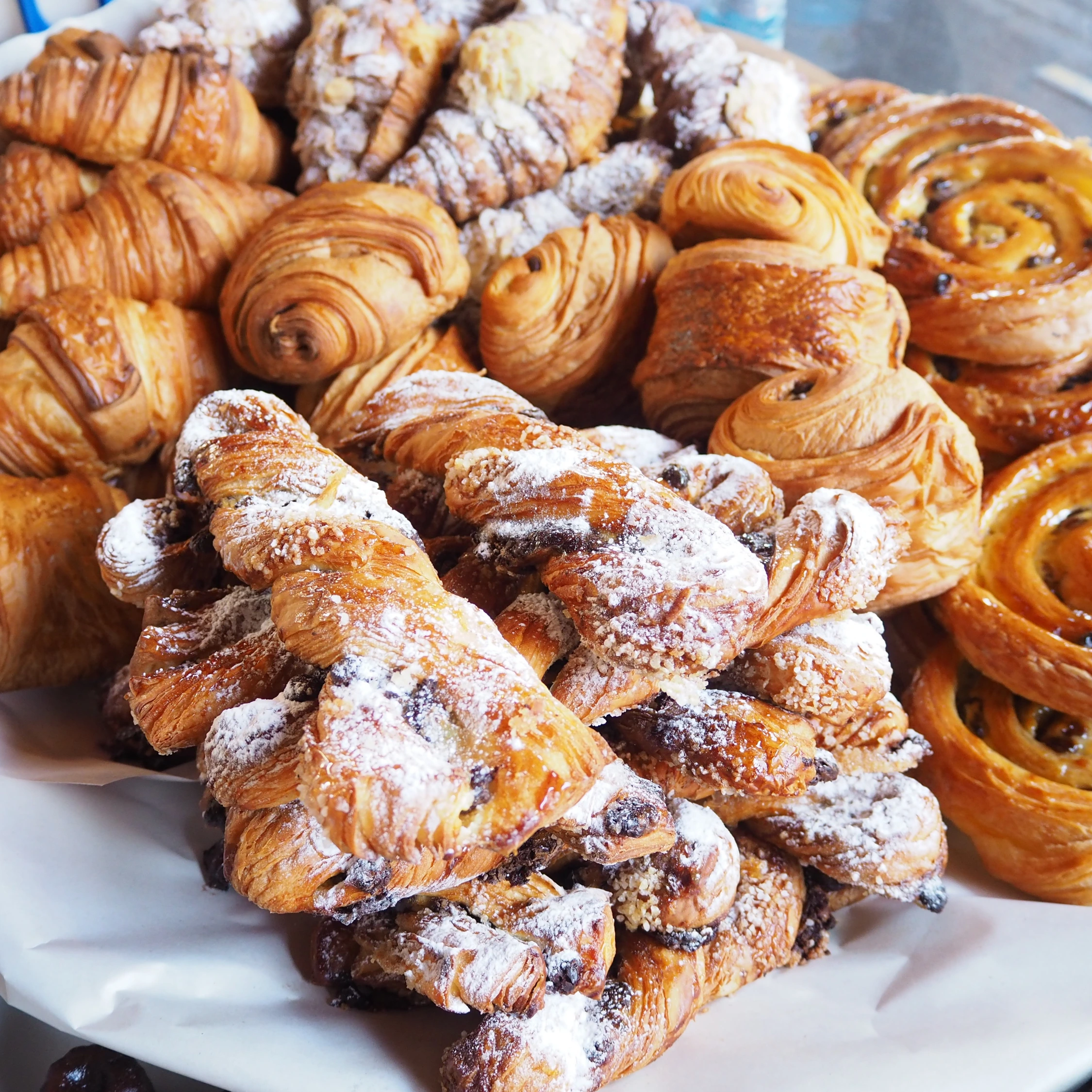 Assortment of freshly baked Korean pastries and breads displayed on a table at Vonado Bakery in Hanoi