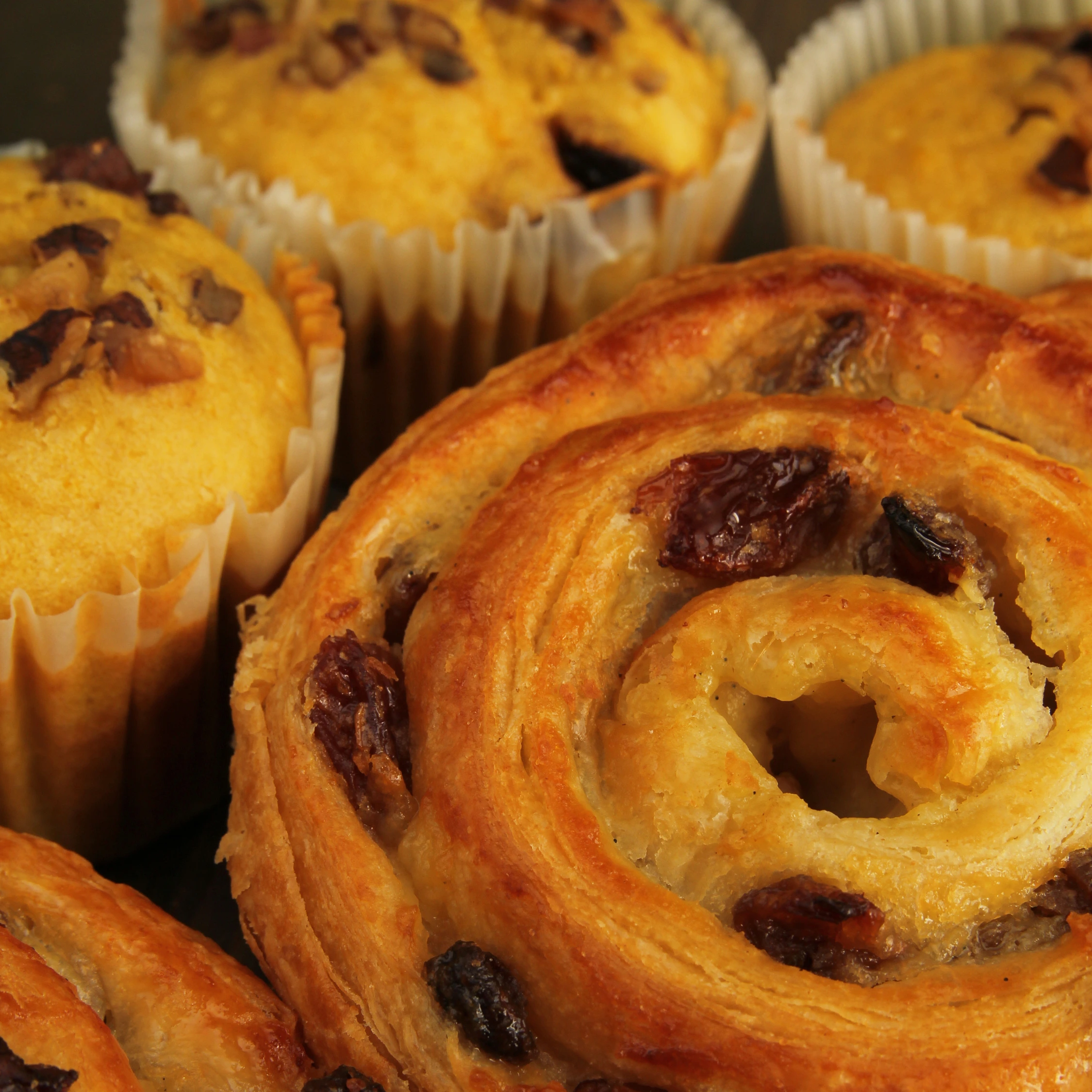 Freshly baked raisin swirl pastry and golden muffins at Vonado Korean Bakery in Hanoi